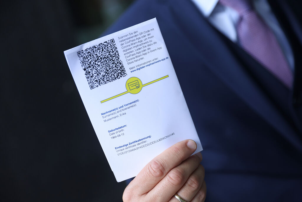 BERLIN, GERMANY - JUNE 10: Ronald Fritz, CovPass project manager at IBM, shows QR code on the European Union Covid-19 vaccination certificate that can be used to activate the CovPass digital version for smartphones following a press conference on June 10, 2021 in Berlin, Germany. CovPass will provide those who have been fully vaccinated against Covid-19 international certification that they can show on their smartphones while traveling. Countries across the EU have been working on a common platform for digital vaccination certification in particular to promote international summer travel and tourism. (Photo by Sean Gallup/Getty Images)